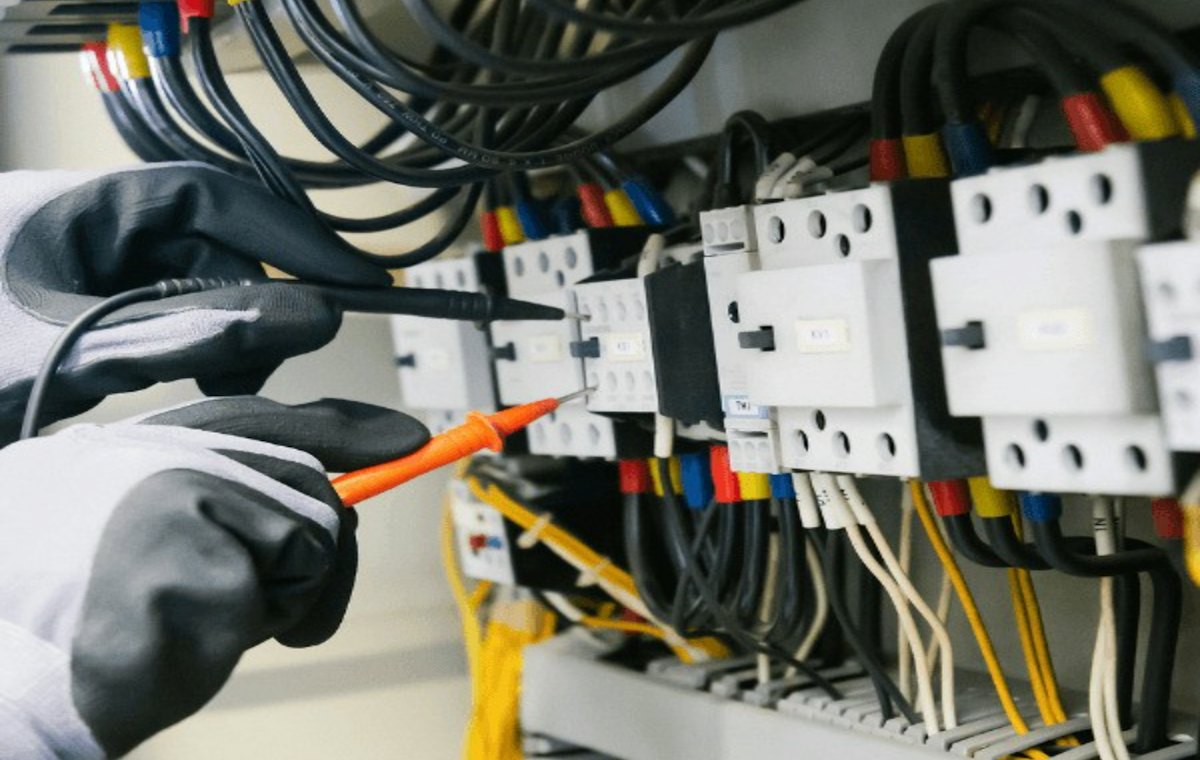 Electrician testing an electrical panel